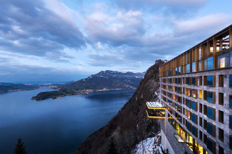 Modern geometric hotel above lake at dusk